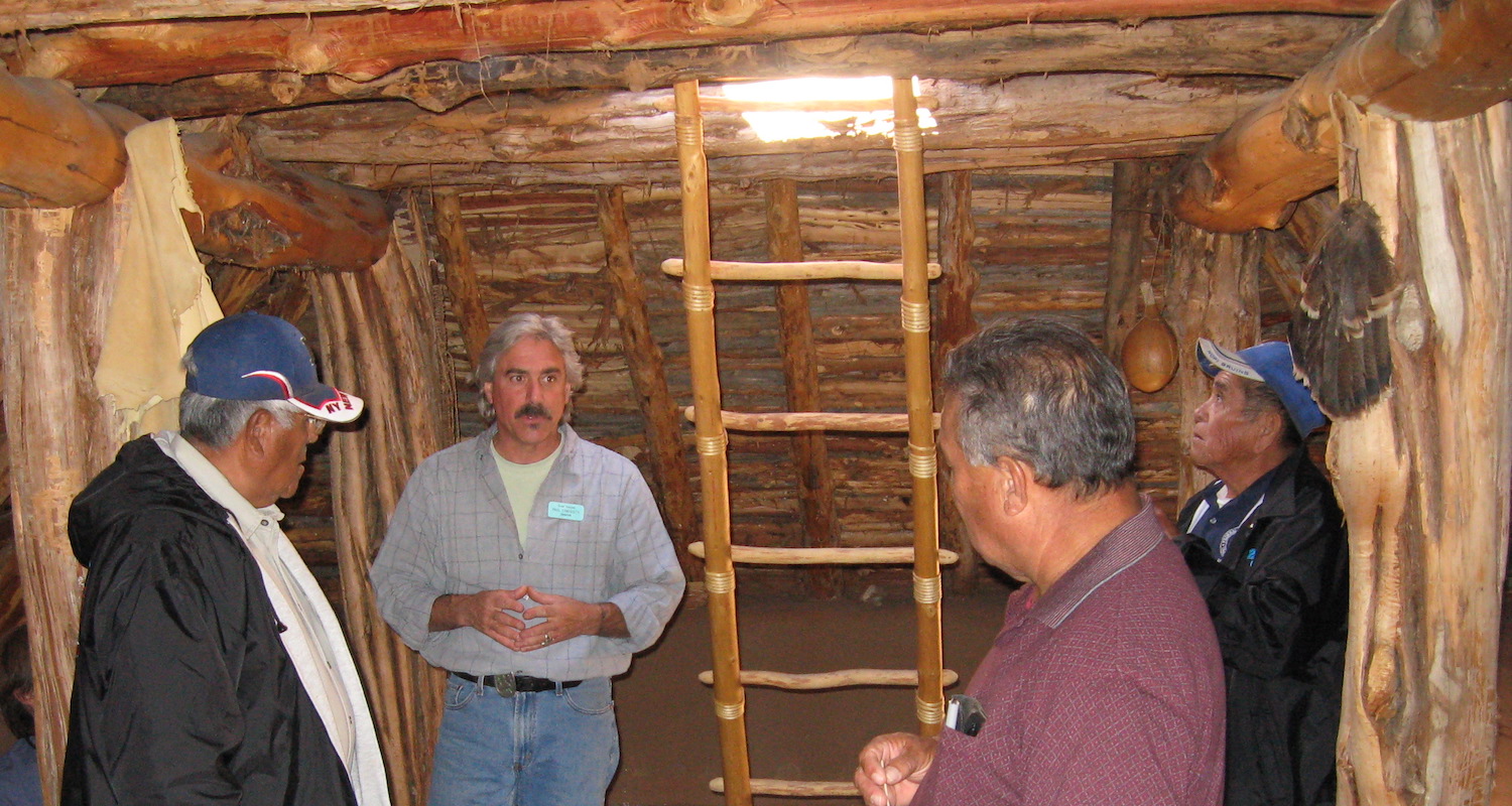 Paul Ermigiotti talking with Hopi elders in a replicated Basketmaker III pithouse
